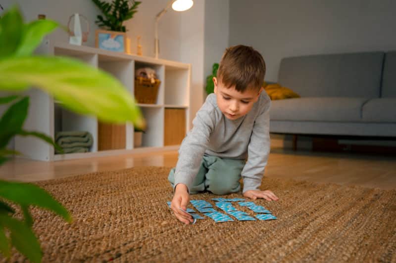 Boy playing with card on floor