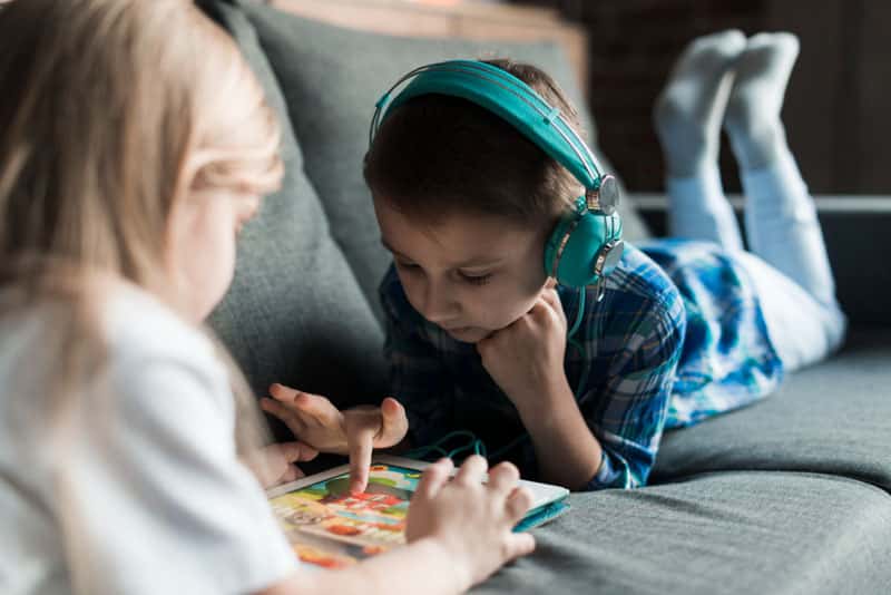 Child listening to headphones while learning