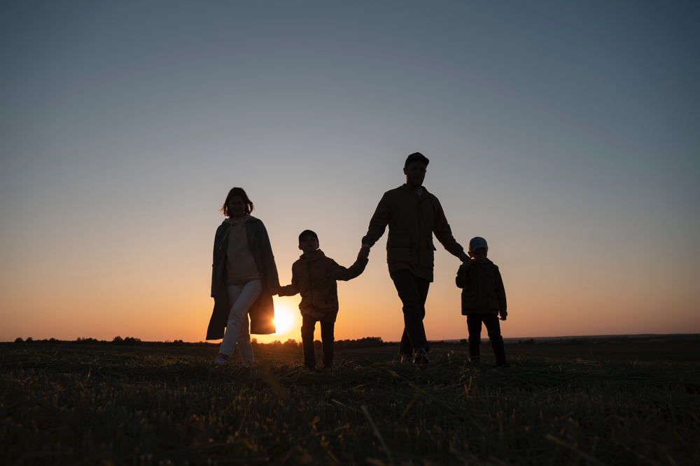 family holding hands in the sunset