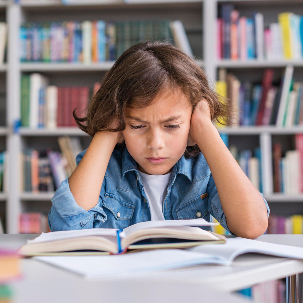 Stressed child in front of a book