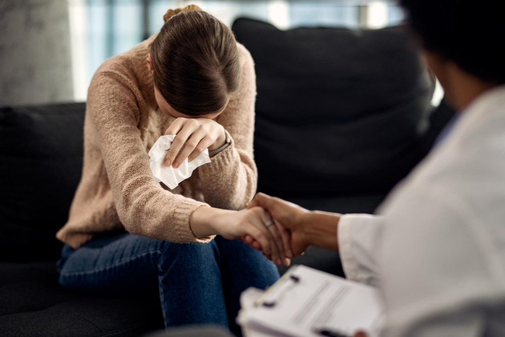 Crying woman holding a tissue, receiving bad news, medical.