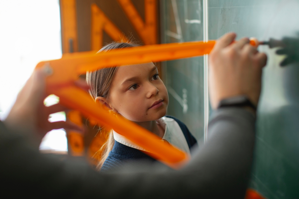 High Ability child practicing angles on a chalkboard