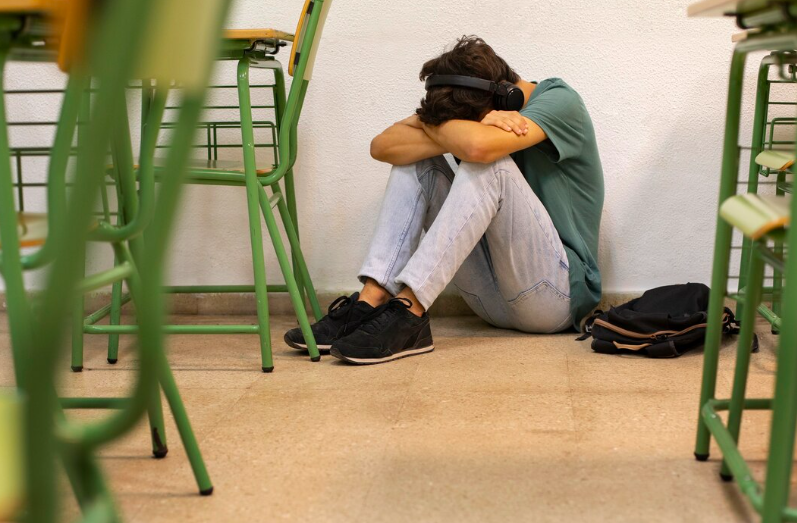 Sad boy crying in the classroom