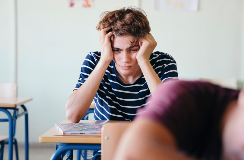 Stressed teen boy at his desk