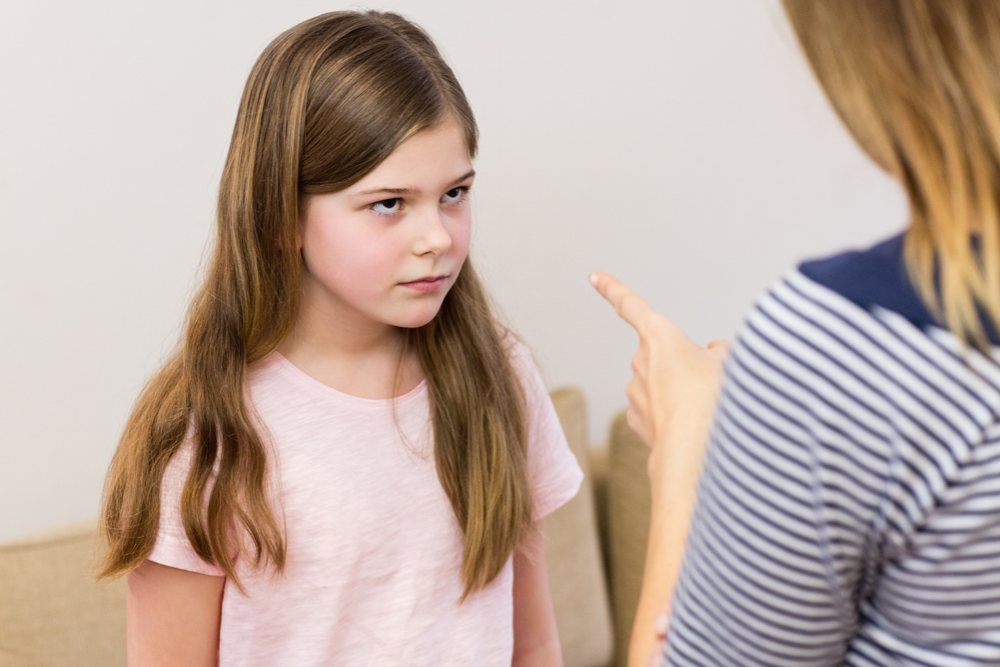 girl being told off by her mother