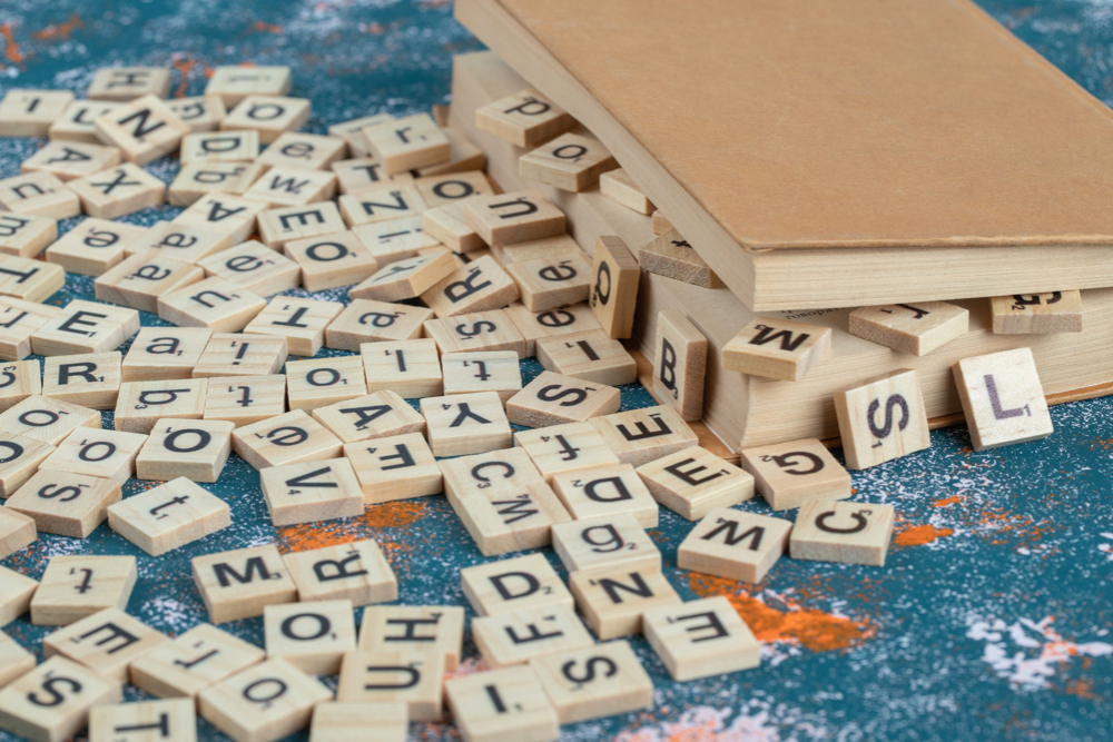 scrabble letter tiles in a book