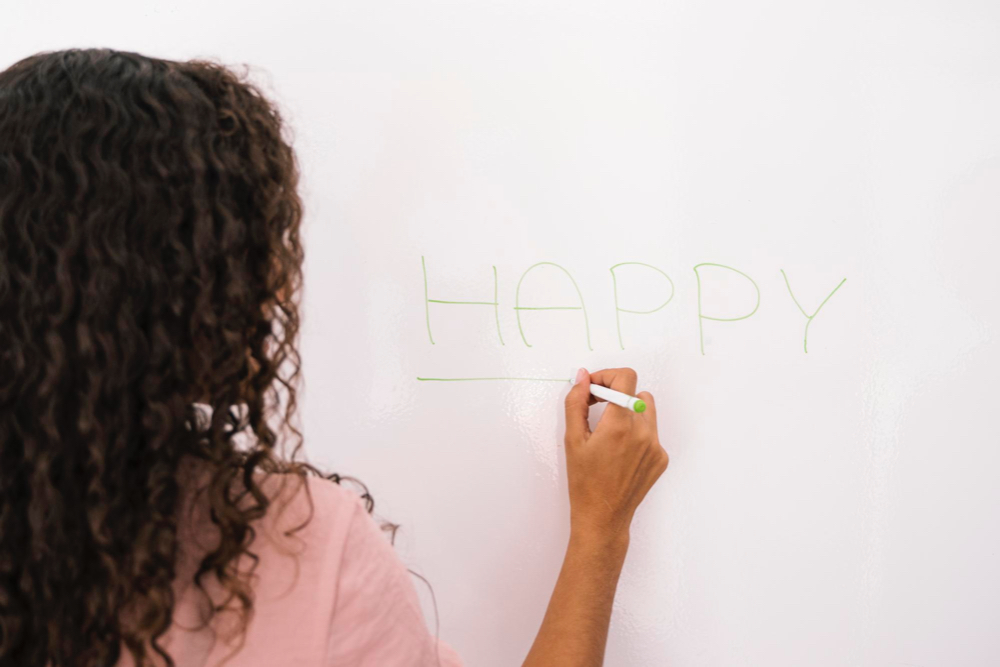girl drawing on whiteboard