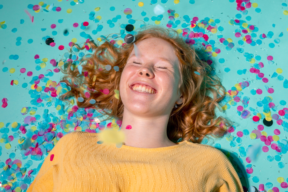 Happy girl smiling in confetti